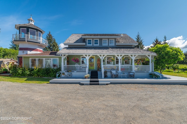 view of front of property featuring a balcony and a porch