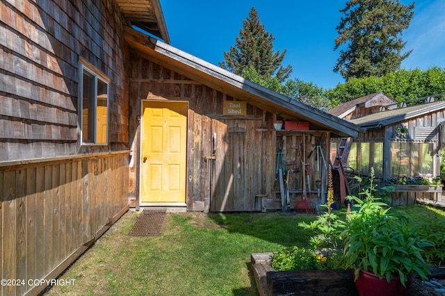 doorway to property with a yard