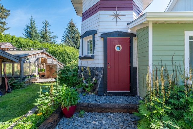 entrance to property with a lawn