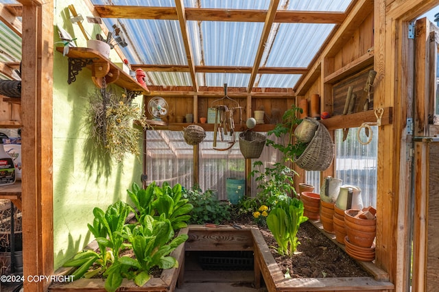 unfurnished sunroom featuring vaulted ceiling