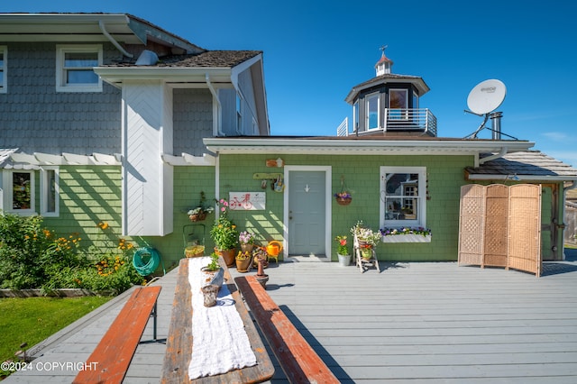 back of property with a wooden deck