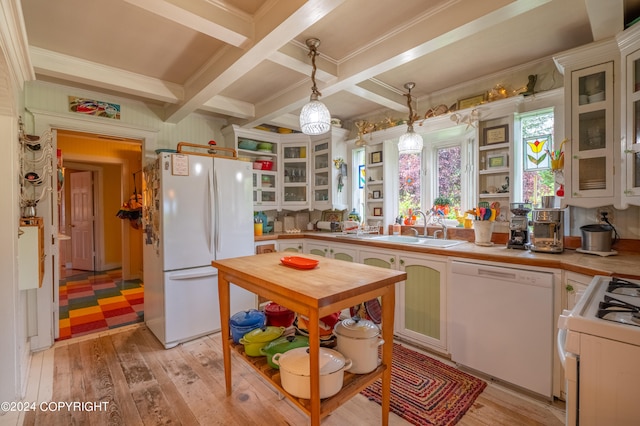 kitchen with white appliances, light wood-type flooring, hanging light fixtures, and coffered ceiling