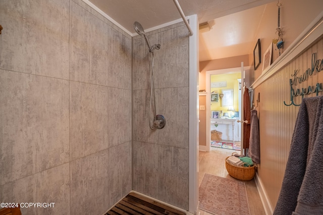 bathroom with walk in shower and tile patterned flooring