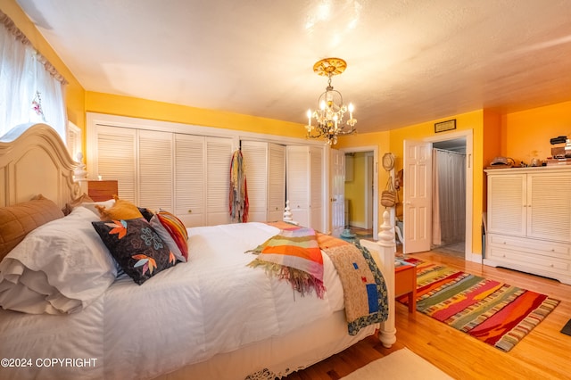 bedroom with a notable chandelier and hardwood / wood-style flooring