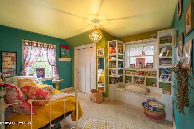 carpeted bedroom featuring a notable chandelier, lofted ceiling, and a closet