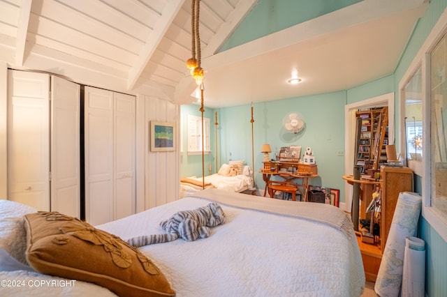 bedroom featuring vaulted ceiling with beams