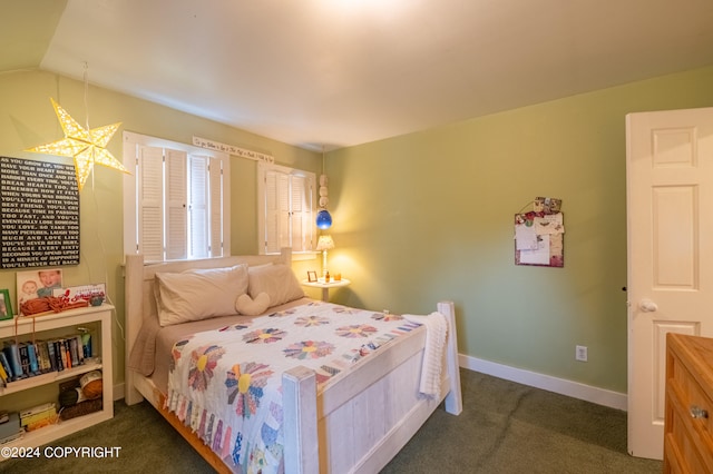 bedroom featuring dark colored carpet and lofted ceiling