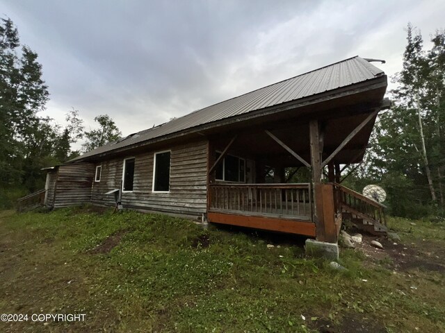 view of side of home with metal roof