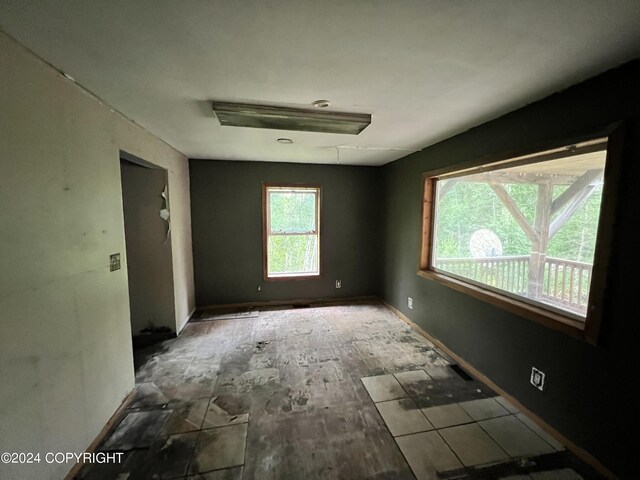 empty room featuring baseboards and wood finished floors