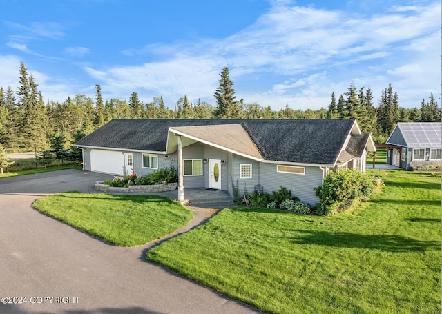 ranch-style home with a garage and a front yard