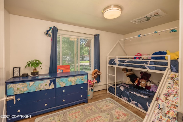 bedroom featuring light hardwood / wood-style floors and a baseboard radiator