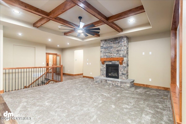 unfurnished living room with ceiling fan, hardwood / wood-style flooring, a fireplace, coffered ceiling, and beamed ceiling