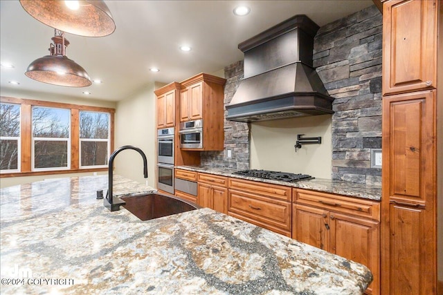 kitchen with stainless steel double oven, custom range hood, light stone counters, and gas stovetop