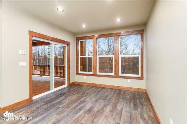 empty room with hardwood / wood-style floors