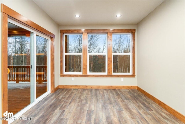 spare room with hardwood / wood-style flooring