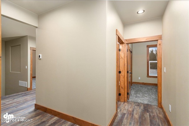 hallway with hardwood / wood-style floors