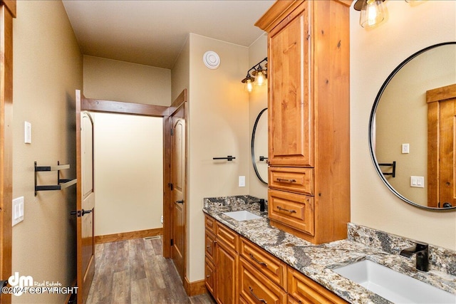 bathroom featuring double sink vanity and hardwood / wood-style flooring