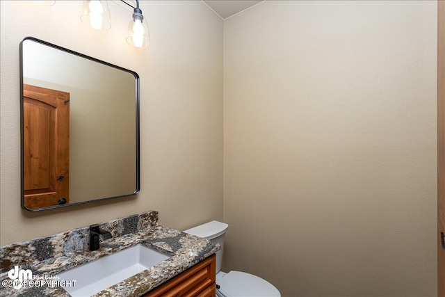 bathroom featuring toilet and vanity