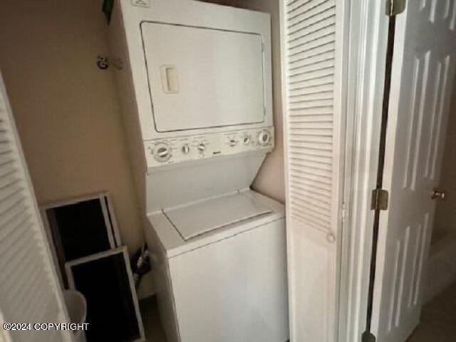 laundry room featuring laundry area and stacked washer / drying machine