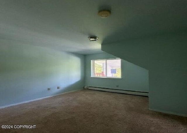 additional living space featuring a baseboard radiator and carpet flooring