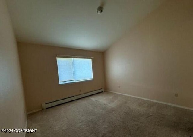 unfurnished room featuring a baseboard radiator, carpet flooring, lofted ceiling, and baseboards