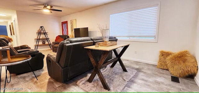 living room featuring hardwood / wood-style floors and ceiling fan