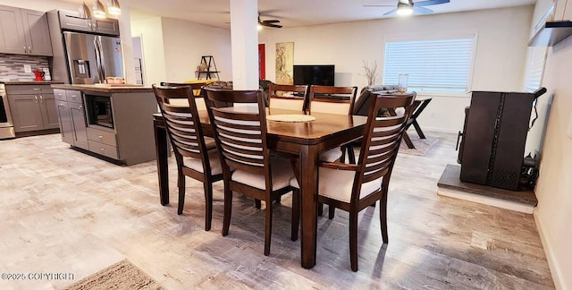 dining room with light hardwood / wood-style floors and ceiling fan