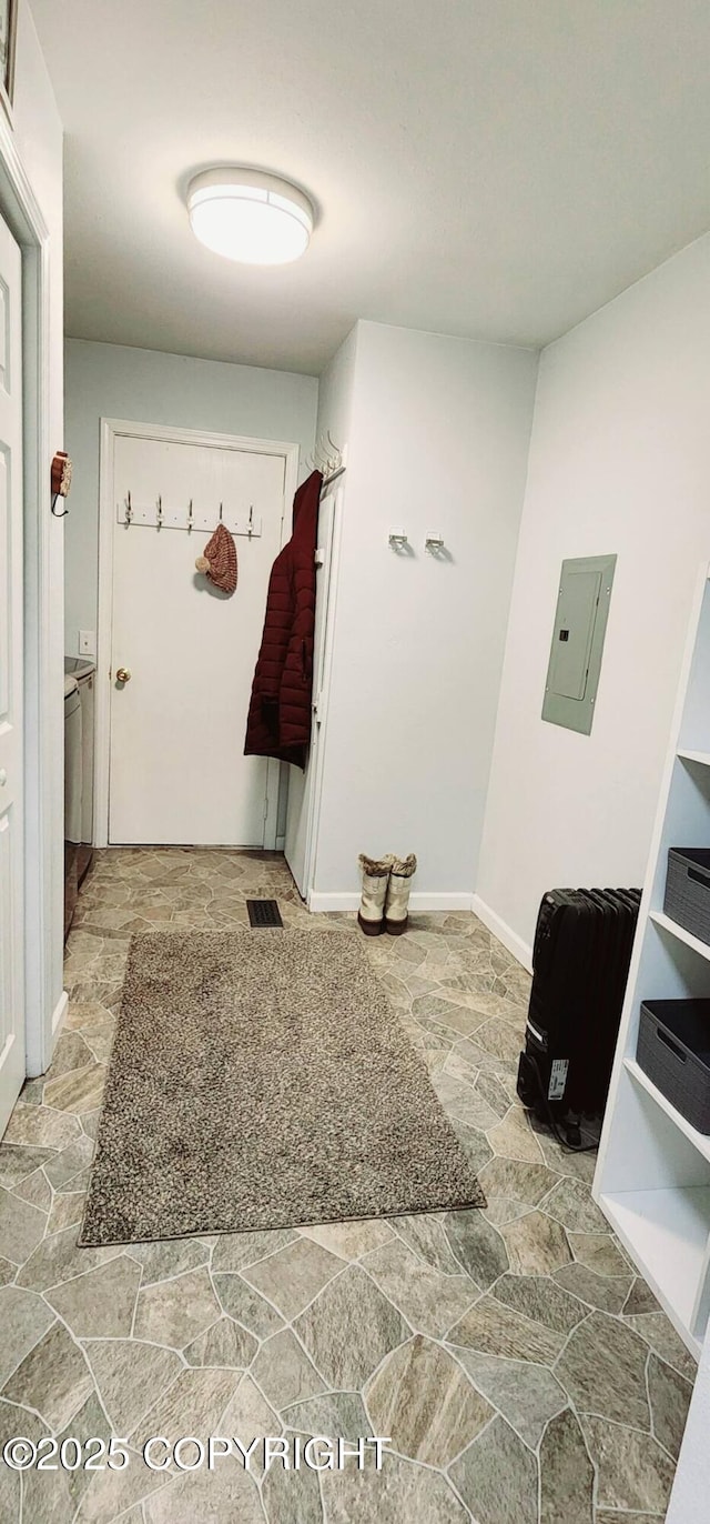 mudroom featuring electric panel