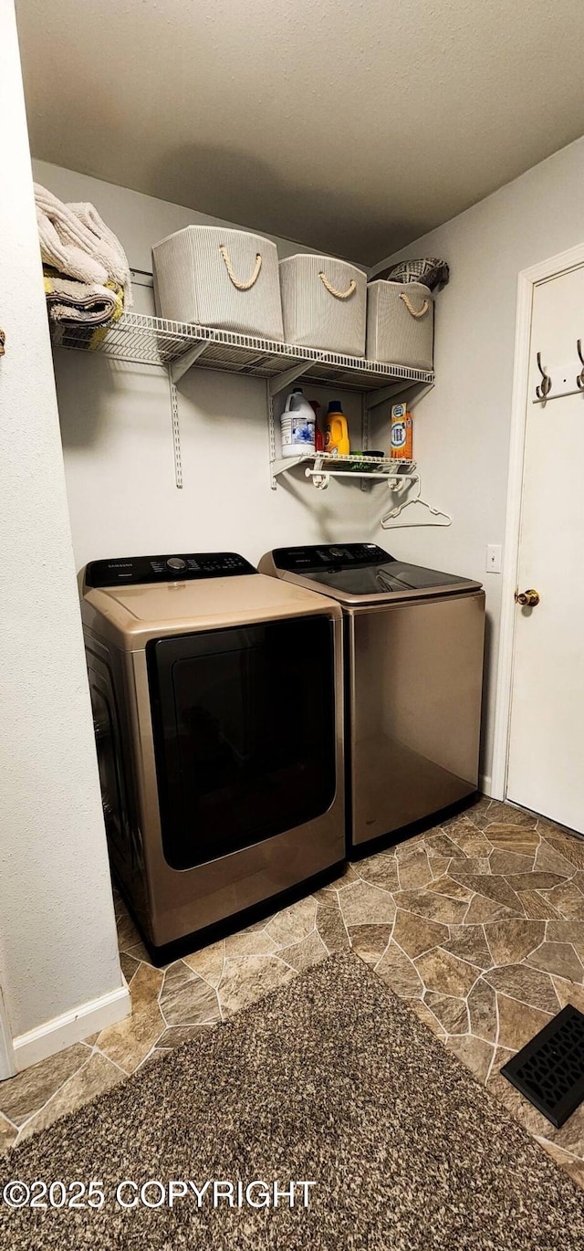 clothes washing area featuring washer and dryer