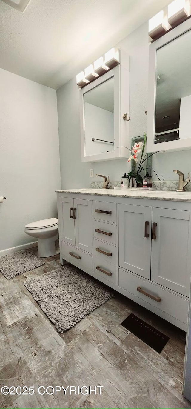 bathroom featuring toilet and vanity