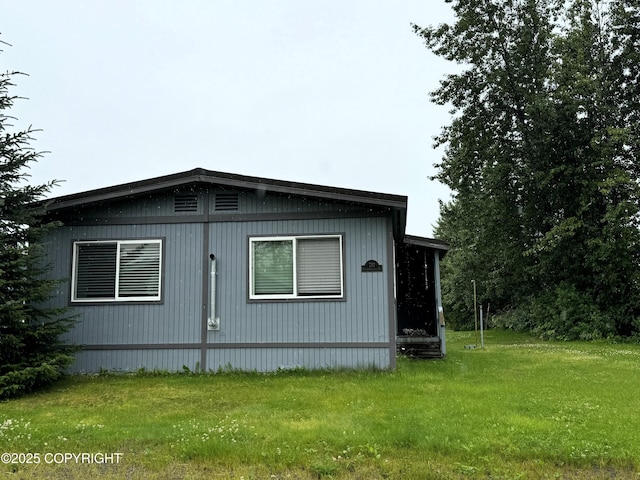 view of property exterior with a lawn