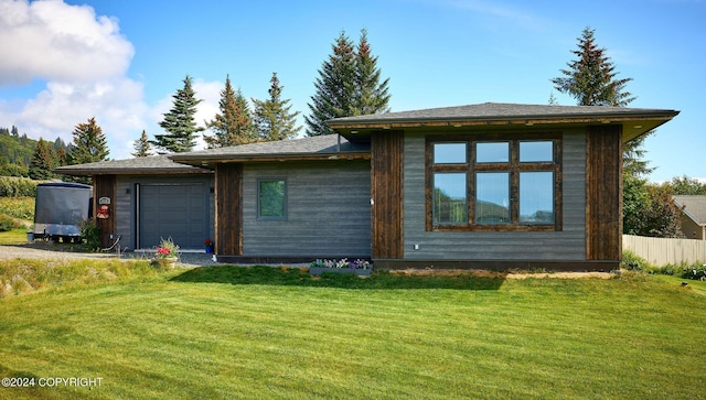 view of front facade featuring a garage and a front lawn