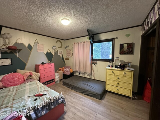 bedroom featuring wood-type flooring and a textured ceiling