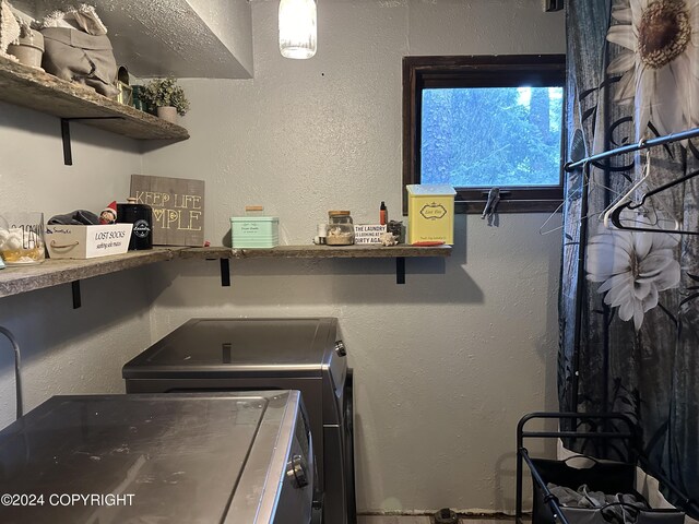 clothes washing area with washing machine and clothes dryer