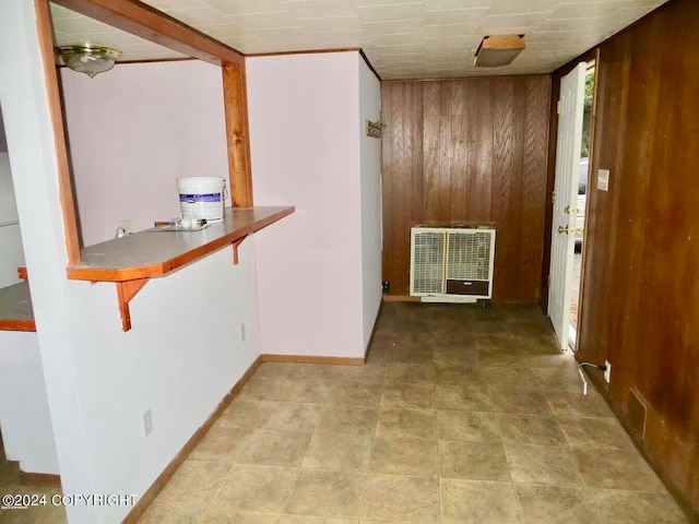 hallway featuring wood walls and tile patterned flooring