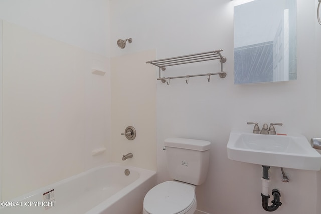 full bathroom featuring sink, tub / shower combination, and toilet