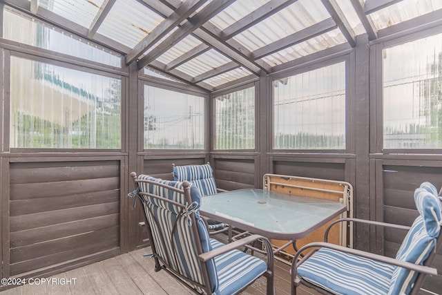 sunroom / solarium with lofted ceiling with beams