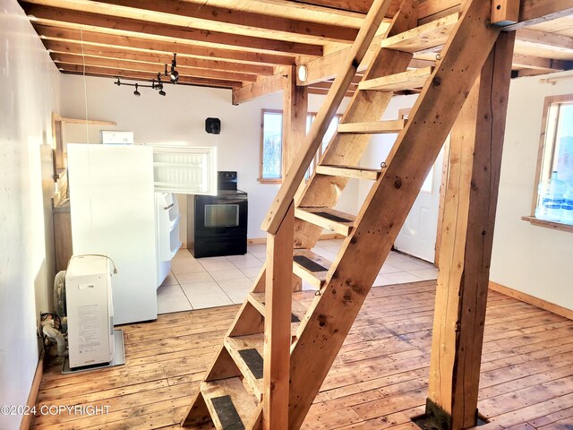 staircase with wood finished floors and baseboards