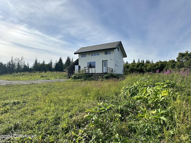 view of front of property with metal roof and a deck