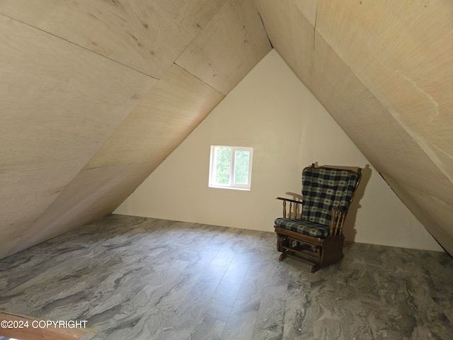 additional living space featuring hardwood / wood-style flooring and lofted ceiling