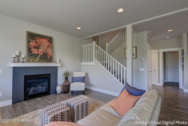 living room with hardwood / wood-style floors and a tile fireplace