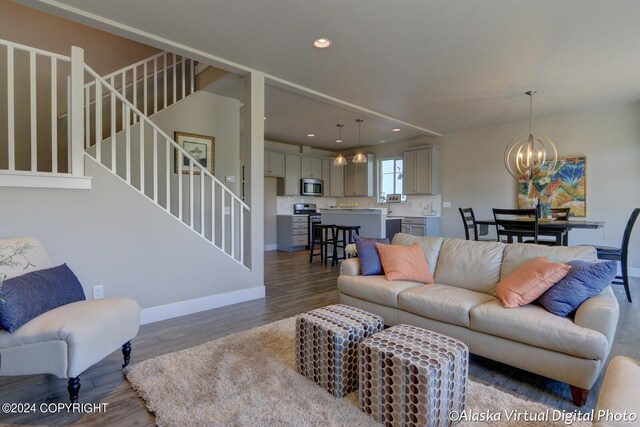 living room featuring an inviting chandelier and dark hardwood / wood-style floors