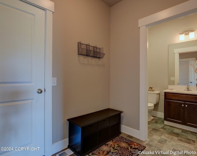 mudroom with light tile patterned floors and sink