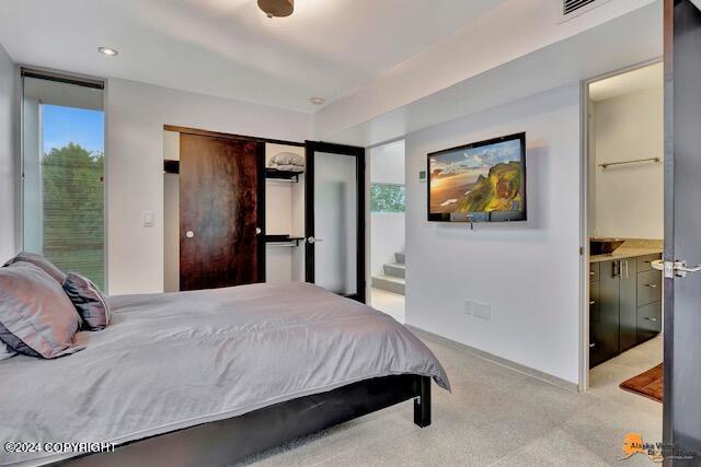 bedroom with visible vents and light colored carpet