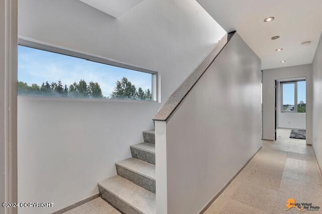 stairway with recessed lighting and baseboards