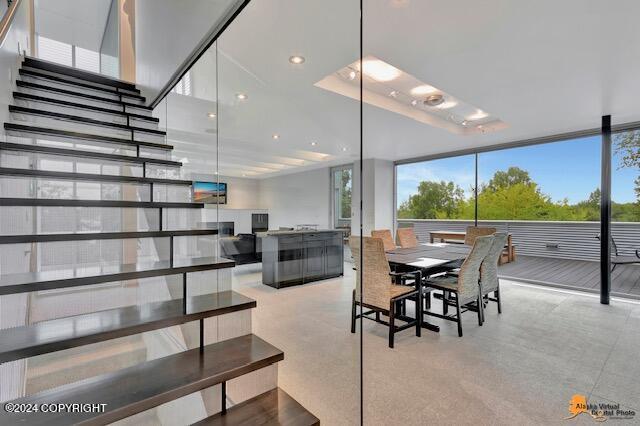 dining space with expansive windows and recessed lighting