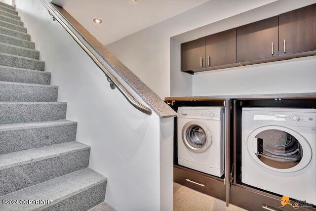 washroom featuring washer and dryer, cabinet space, and recessed lighting