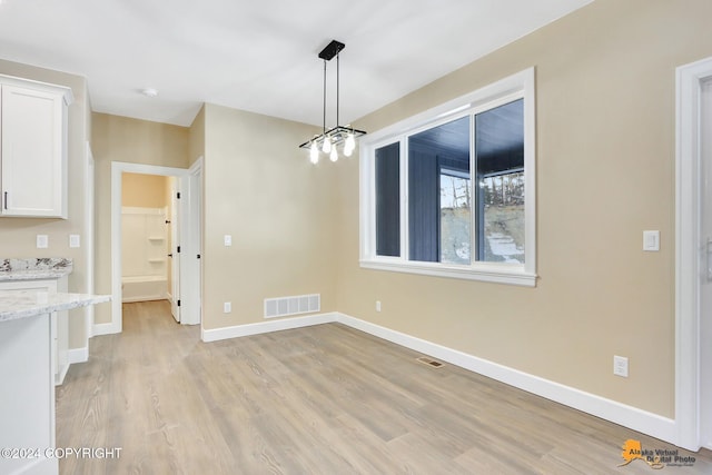 unfurnished dining area featuring light hardwood / wood-style floors