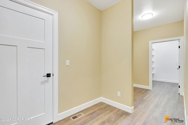 corridor with hardwood / wood-style floors