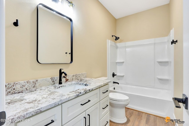 full bathroom featuring vanity, toilet, shower / bath combination, and hardwood / wood-style floors